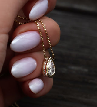 14kt gold teardrop diamond side halo bezel necklace