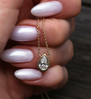 14kt gold teardrop diamond side halo bezel necklace